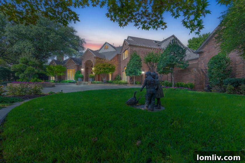Grand entrance of a luxurious North Dallas estate, showcasing meticulous landscaping and architectural elegance.