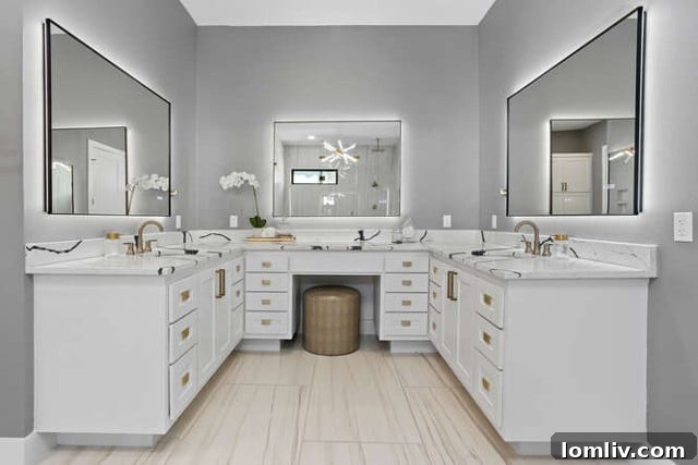 Spacious primary bathroom with abundant cabinetry, dual vanities, modern fixtures, and ample storage solutions