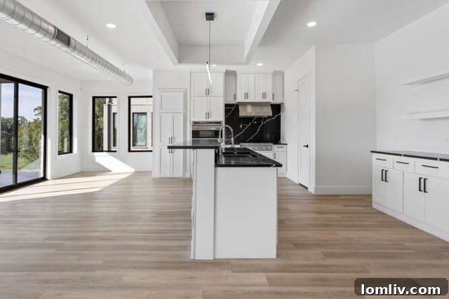 Second full kitchen in the lower level walk-out basement, featuring modern appliances and expansive gliding doors opening to the outdoor living area