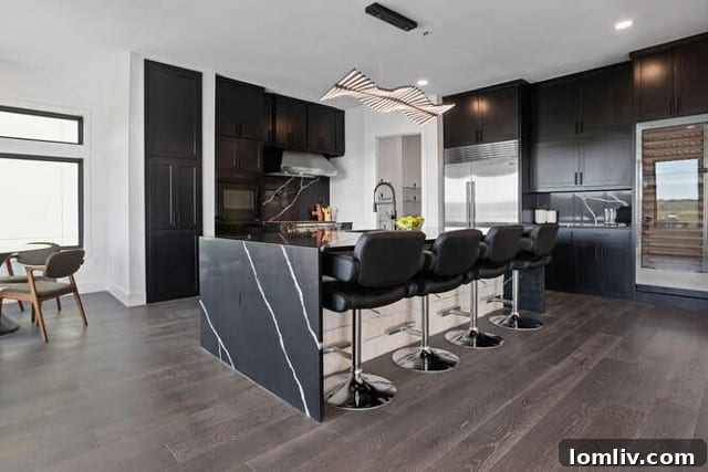 Gourmet kitchen in a luxury Fort Worth home with a large island featuring a waterfall counter, high-end appliances, and an integrated wine fridge