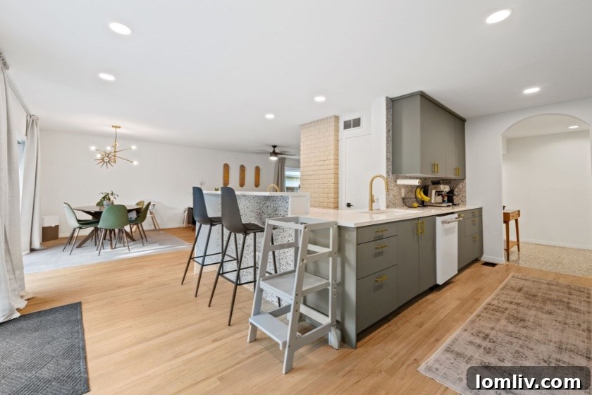 Erick and Chelsea Sigmond's Stunning East Dallas Ranch Transformation 14 After renovation secondary bathroom with olive green tile, modern mirrors, and Schoolhouse Electric light
