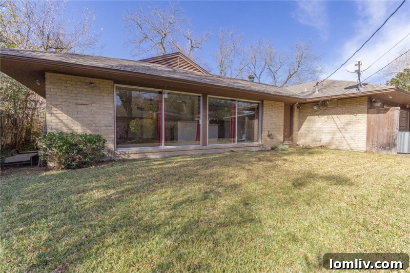 Erick and Chelsea Sigmond's Stunning East Dallas Ranch Transformation 9 Before renovation exterior with overgrown plants and lack of landscaping