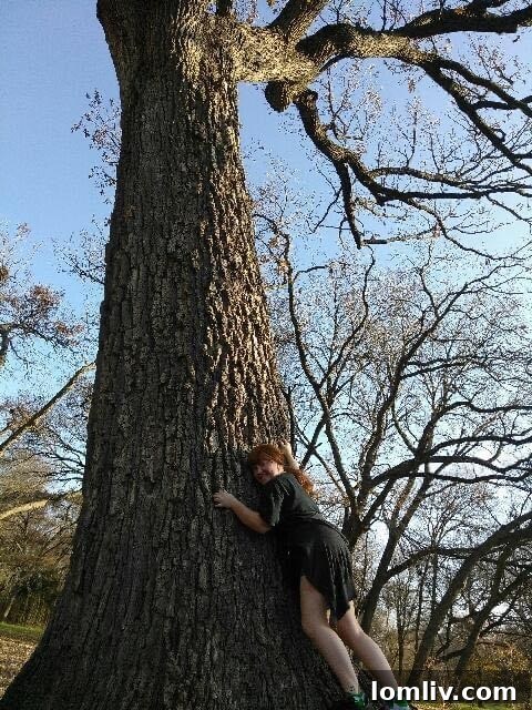 Laura Ostteen with a tree, highlighting her long-standing passion for environmental preservation.