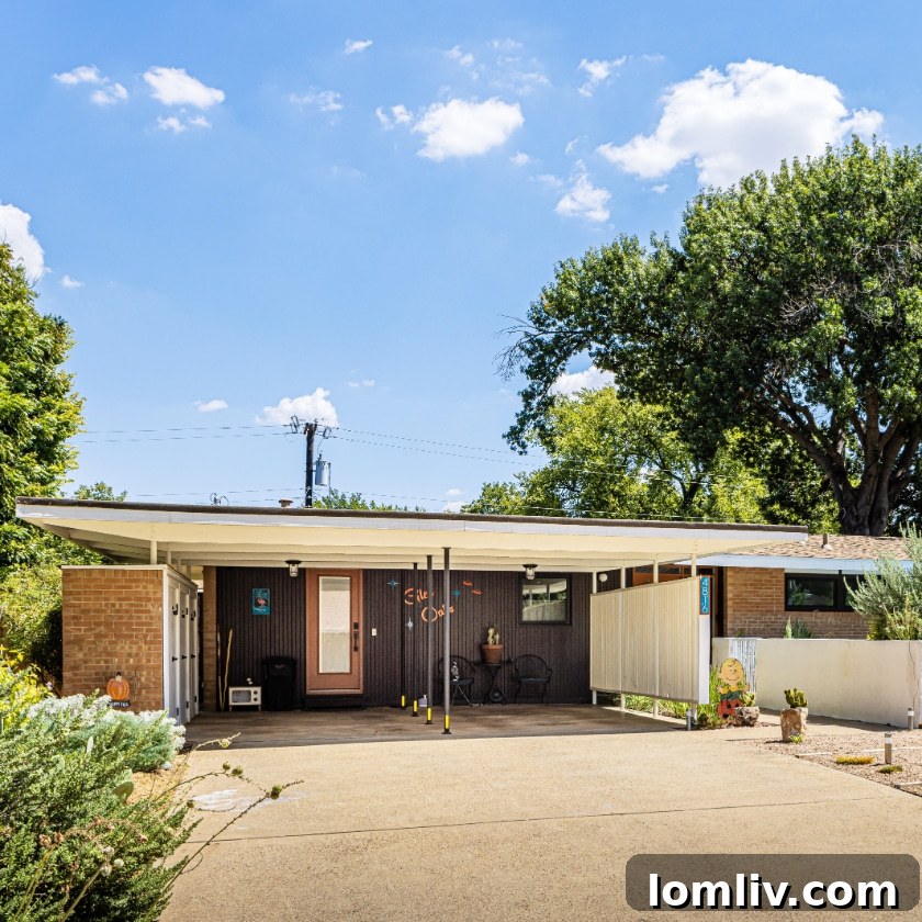 A minimalist floating carport provides protection for vehicles and strategically shields the house from direct harsh sunlight, a clever mid-century design feature.