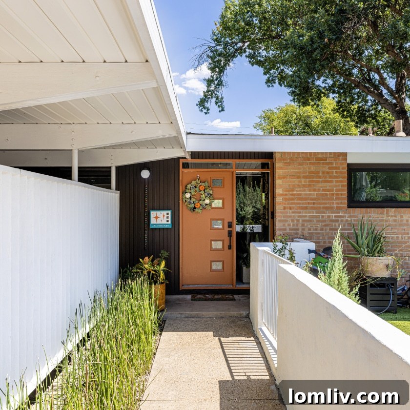 A spacious and private front courtyard, artfully concealed from the street, provides a welcoming and intimate entry experience to the mid-century home.