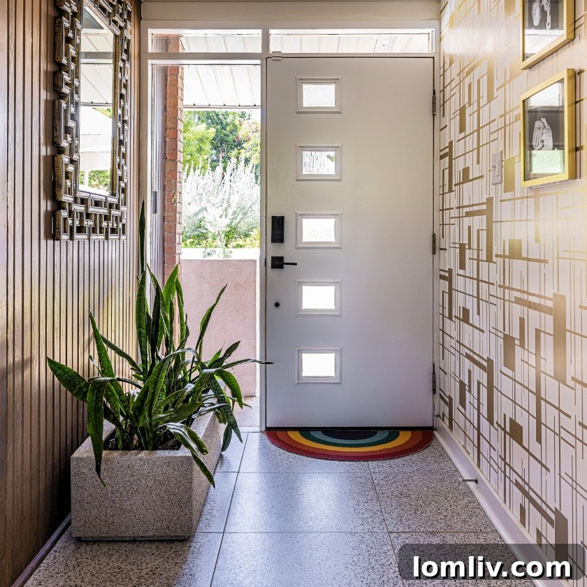 Original wood paneling cleverly disguises a coat closet and seamlessly extends outdoors, blurring the lines between indoor and outdoor spaces in this mid-century modern home.