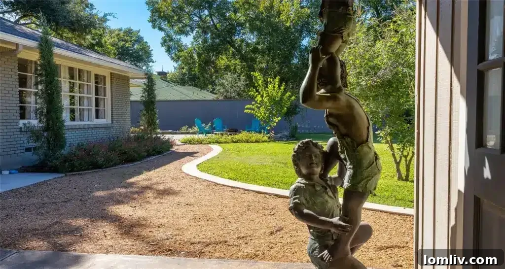 Preston Hollow's Midcentury: The Home That Weathered Judo Outlaws and Tornados 12 Expansive and private backyard of the Dallas home, featuring a lush green lawn and mature trees, perfect for outdoor recreation
