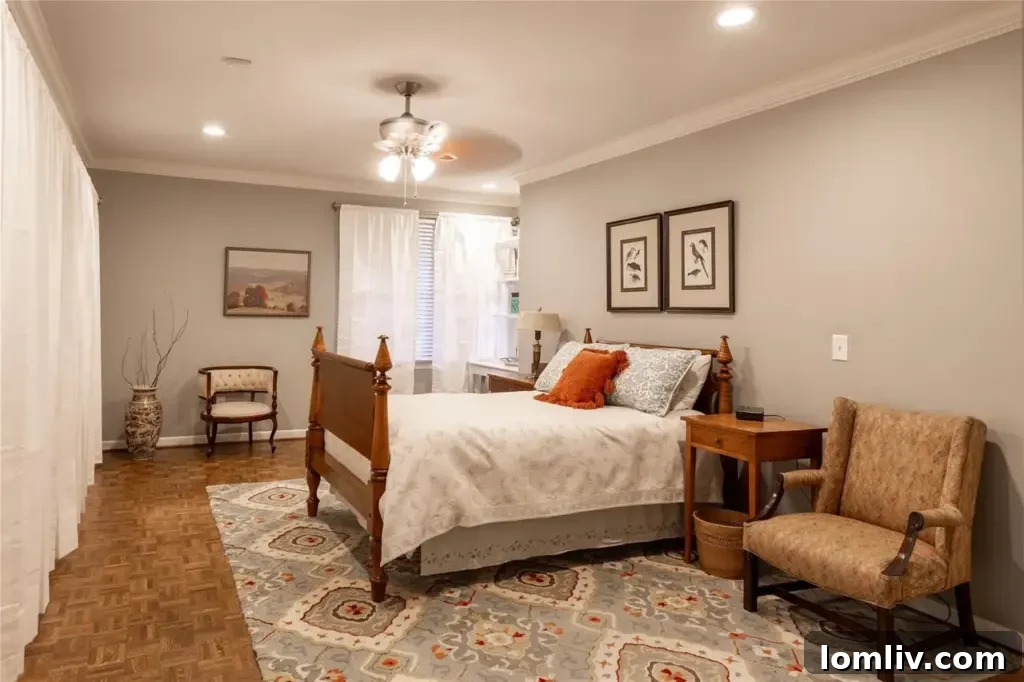 Preston Hollow's Midcentury: The Home That Weathered Judo Outlaws and Tornados 8 Cozy and inviting bedroom with polished hardwood floors and abundant natural light, showcasing refined design