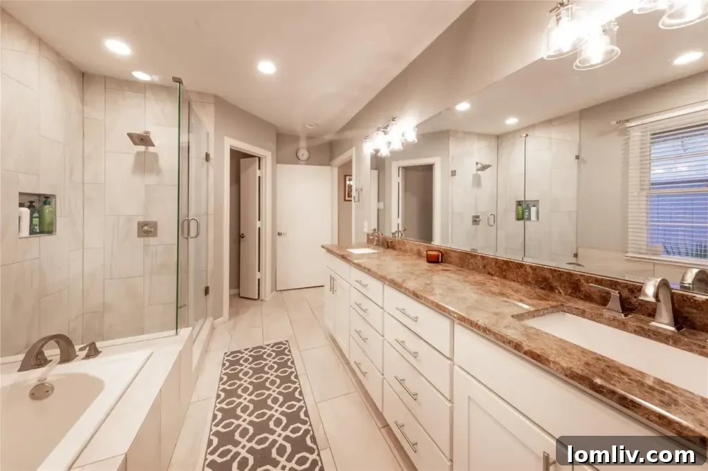 Preston Hollow's Midcentury: The Home That Weathered Judo Outlaws and Tornados 9 Spacious primary bathroom featuring a modern double vanity, elegant finishes, and a large walk-in shower