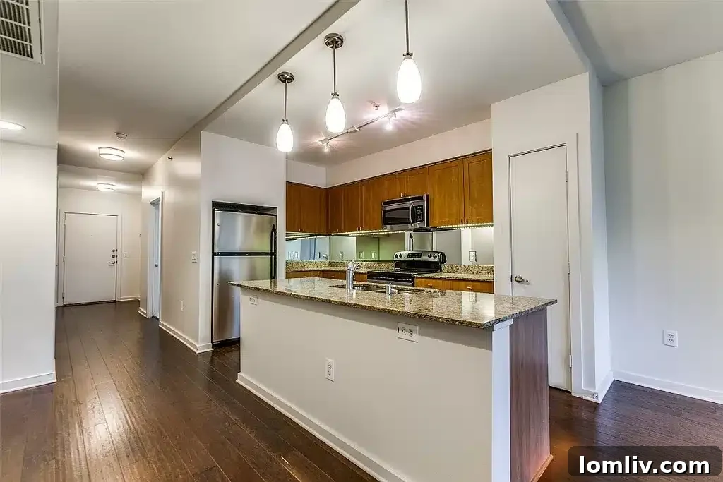 SOHIP Condo Wycliff & Lemmon Your Urban Lifestyle Awaits 5 Modern kitchen with natural-finished cabinets, granite countertops, and stainless steel appliances
