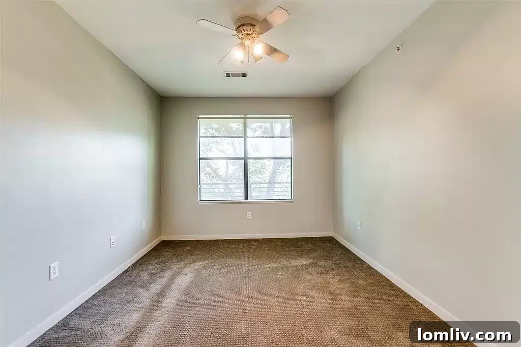 SOHIP Condo Wycliff & Lemmon Your Urban Lifestyle Awaits 6 Serene primary bedroom with cozy carpeting and large window offering canopy views