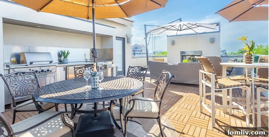 Elevated Living: Rooftop Terraces, Golf Simulators, and Walk-In Pantries Lead Home Trends 3 Elegant rooftop terrace featuring a full outdoor kitchen with a grill, comfortable lounge seating around a fireplace, and stunning city views at dusk.