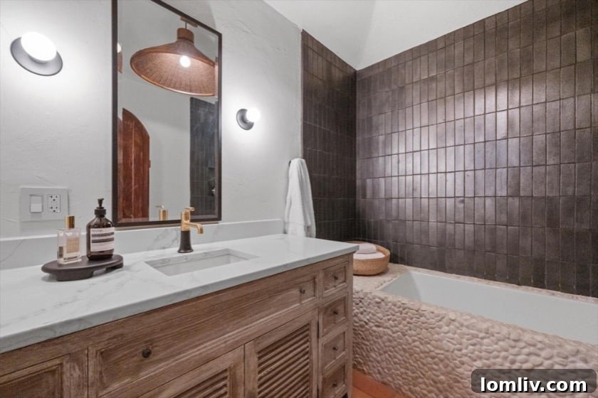 The Little House That Dared to Dream: A Quirky Gem's Bold New Look 9 Daydream Photography: Elegant bathroom design featuring unique mirror and lighting in the Carnes Street house renovation