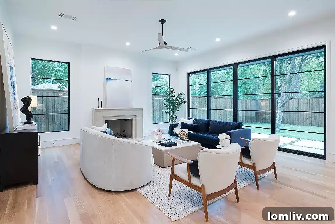 Academic Growth Spurs Dallas Housing Demand 4 The spacious living room in this contemporary home features expansive windows that allow abundant natural light to brighten the interior, creating an inviting atmosphere.