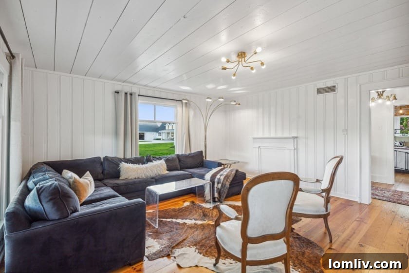 Claim Your Three Acres of Kaufman's Legacy at The Thurman Place 15 Spacious modern living room with fireplace and polished concrete floors in the main house