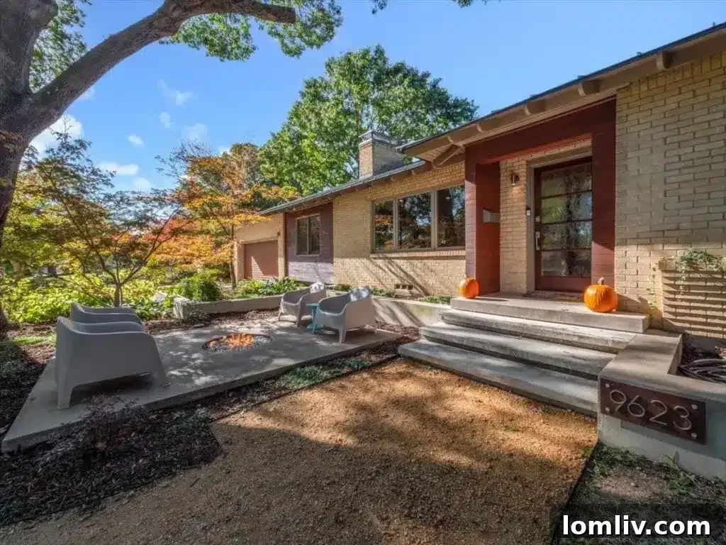 Welcoming exterior of 9623 Athlone Drive with a front yard firepit, surrounded by mature trees, inviting community interaction.