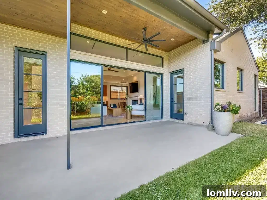 Ridgecrest Village: A Modern Masterpiece 13 A tranquil backyard featuring a spacious covered patio, ideal for outdoor dining and relaxation, alongside a meticulously maintained lawn.