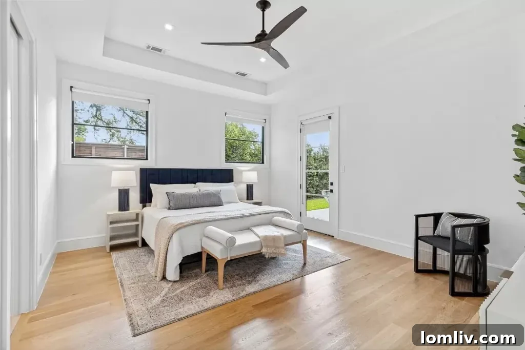 Ridgecrest Village: A Modern Masterpiece 9 A serene primary bedroom suite with vaulted ceilings, elegant decor, and direct access to the private backyard oasis.