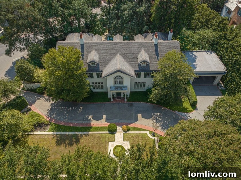 Unveiling Hal Thomson's Highland Park English Country House: A Wilson Fuqua Exploration 12 Expansive Rear View of the Historic Highland Park Home with Landscaped Grounds