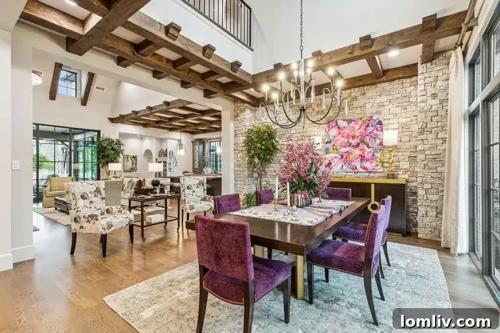 An elegant dining room with a grand table, sophisticated lighting, and a panoramic view, showcasing the home's open-concept design.