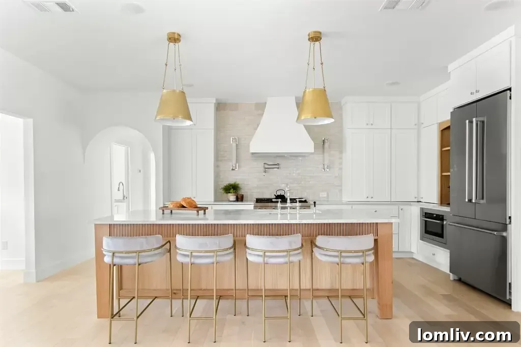 A modern, chic kitchen with gleaming pendant lights, marble countertops, and a stylish breakfast bar, perfect for Thanksgiving brunch.