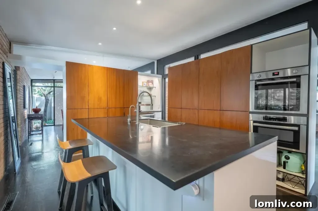 Another view of the elegant kitchen featuring an induction cooktop and high-end appliances