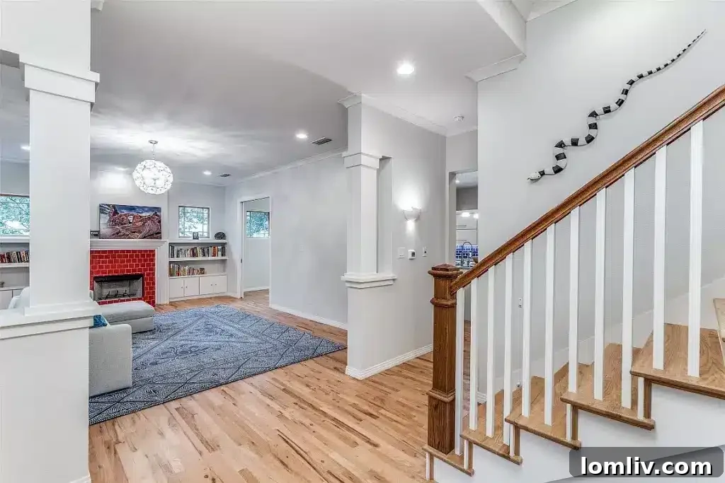 Inviting living space featuring a colonnaded den, perfect for relaxation or study