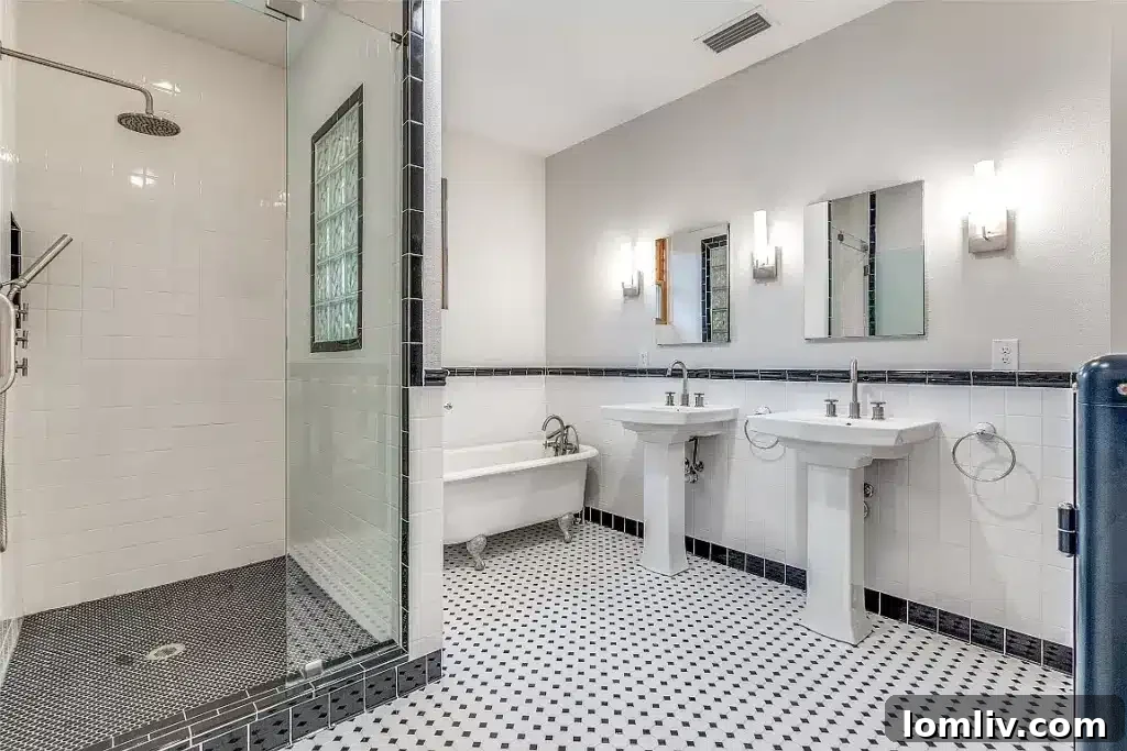 Luxurious primary ensuite bathroom with a clawfoot tub, vintage fixtures, and ornate tilework