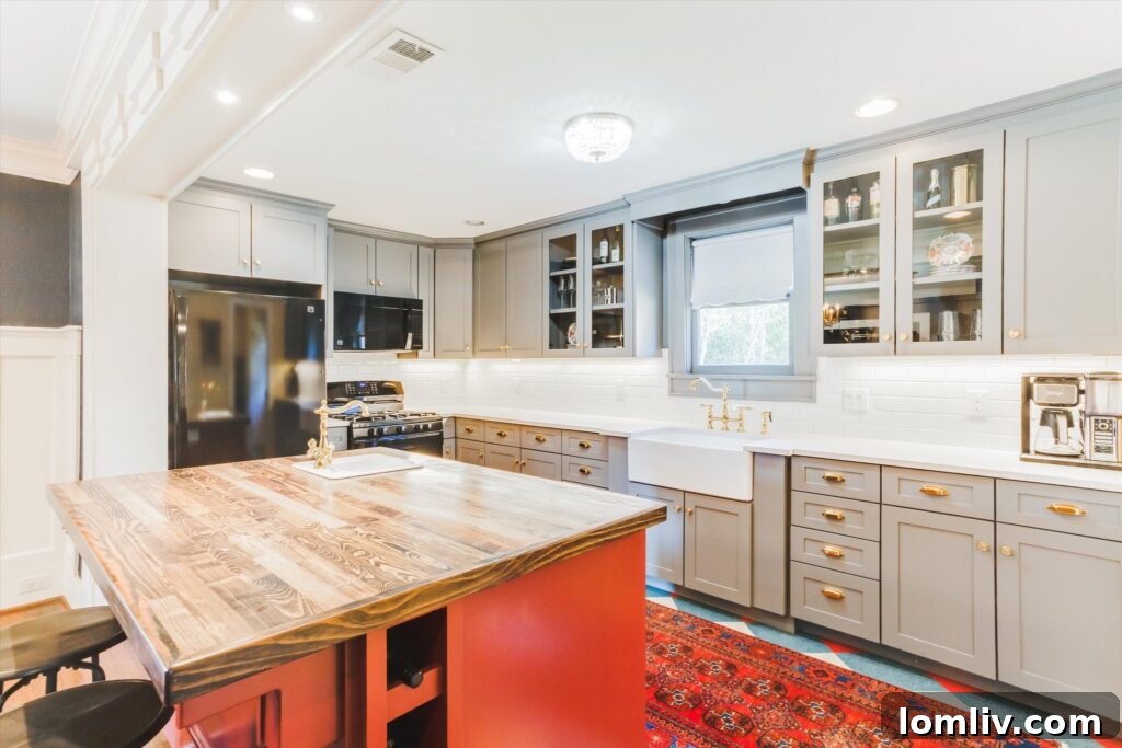 Modern Open-Concept Kitchen with Red Island and Brass Accents