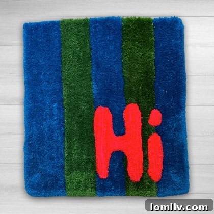A colorful hand-tufted rug with the phrase 'Hi Y'all' in a playful font