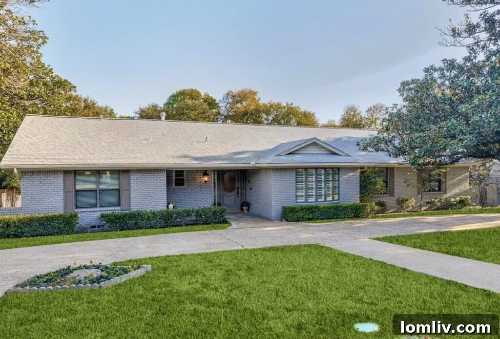 The classic and attractive curb appeal of 8238 San Leandro Drive, showcasing soft slate finishes and a meticulously manicured lawn.
