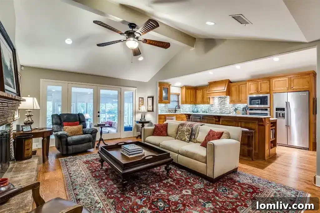 Spacious open-concept living room with a warm hearth, elegant wood-burning fireplace, and high beamed cathedral ceilings.
