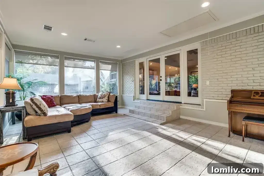 Modern gourmet kitchen with granite countertops, gas range, custom cabinetry, and a large center island, perfect for entertaining.