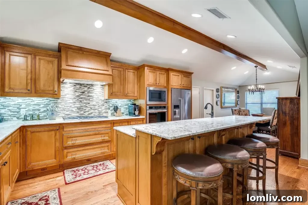 Bright and airy kitchen featuring an oversized island and seamless access to dining and living areas.