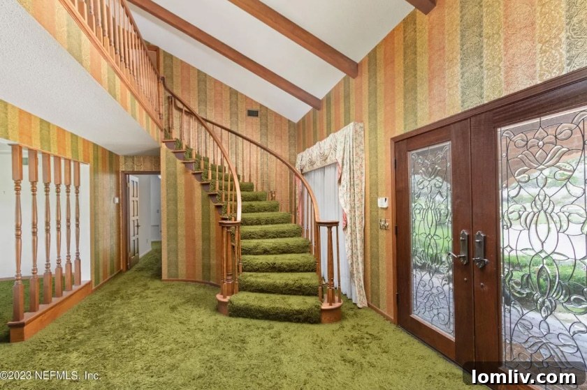 Matching green wallpaper and shag carpeting in a Midcentury Modern hallway, showcasing cohesive interior design