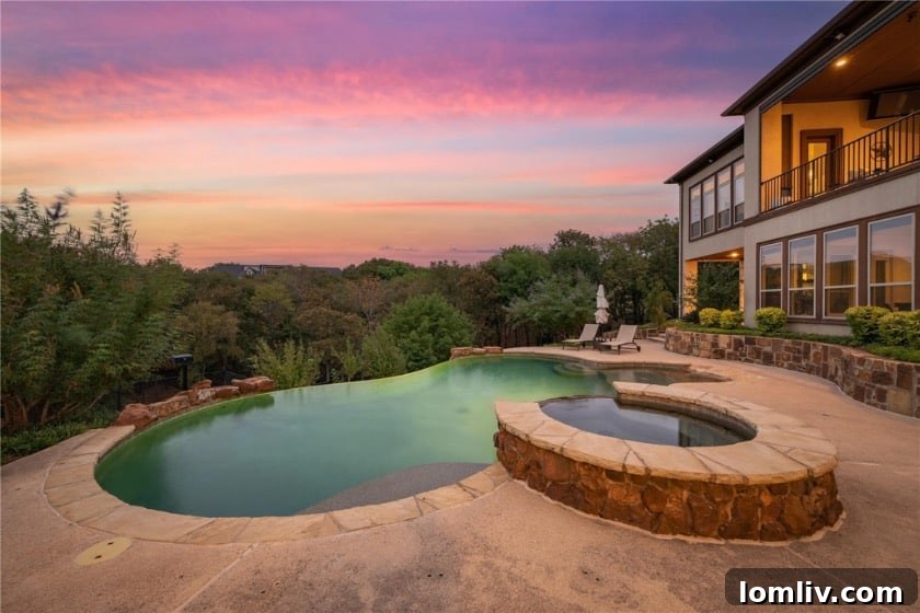 Point Noble's Crown Jewel: Historic Grandeur Meets Unrivaled Views 6 Grand front exterior view of the luxury home at 1501 Noble Way in Flower Mound, featuring a circular drive and manicured lawn.