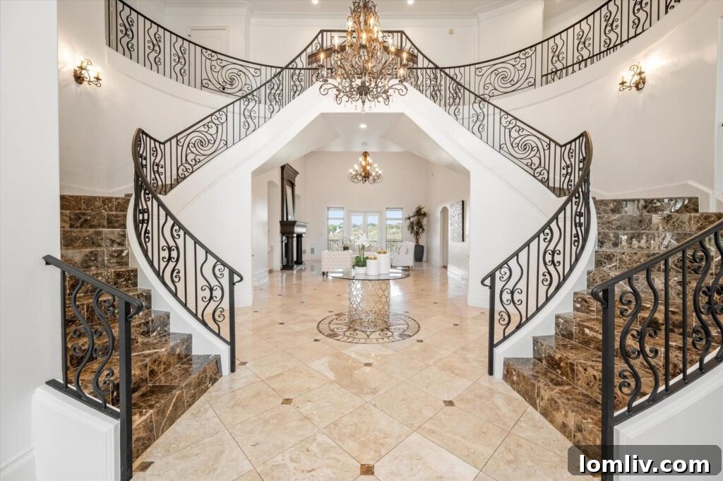 Point Noble's Crown Jewel: Historic Grandeur Meets Unrivaled Views 7 Elegant foyer of 1501 Noble Way, showcasing two grand staircases and high ceilings.