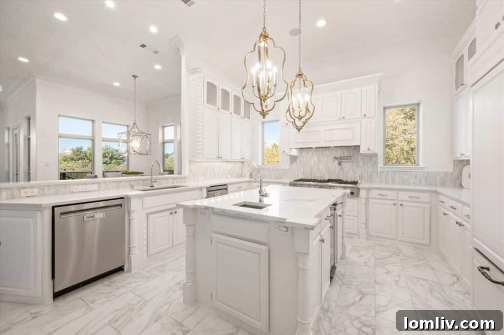 Point Noble's Crown Jewel: Historic Grandeur Meets Unrivaled Views 8 Luxurious all-white kitchen with ample counter space and modern appliances in the Noble Way residence.