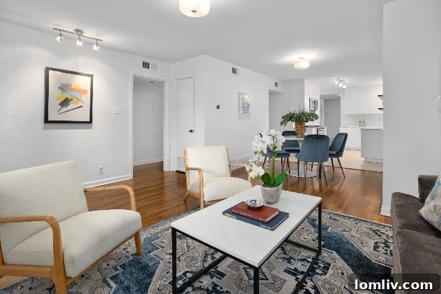 Open concept living, dining, and kitchen area at 4000 Kenley Street, featuring beautiful hardwood floors