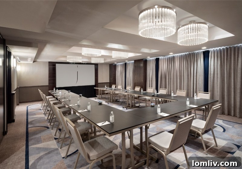 A modern and elegant pre-function area with stylish seating and artwork within The Joule Dallas