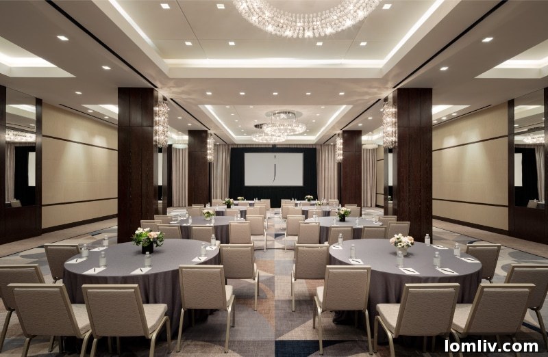 A close-up of a luxurious, patterned carpet and elegant wall covering in The Joule's renovated ballroom
