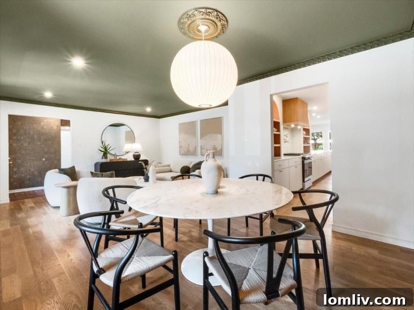 East Dallas's Newest Marvel by Sunscout Studio 7 A vibrant dining room showcasing an incredible feature wallpaper that blends classic charm with modern sophistication.