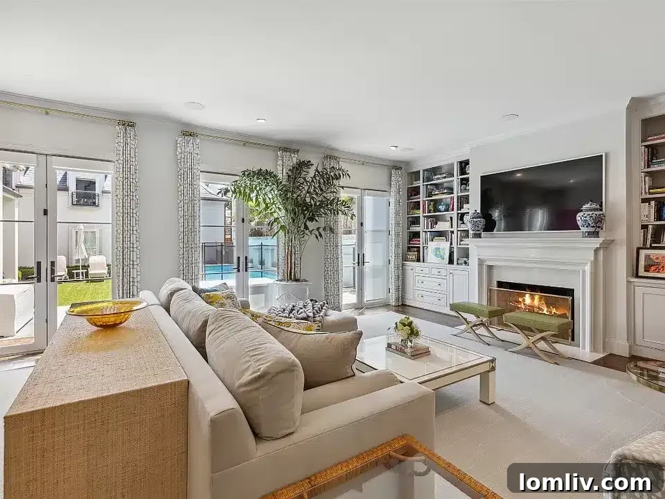 French doors opening to a meticulously landscaped backyard with a sparkling pool at 3637 Maplewood Avenue, Highland Park.