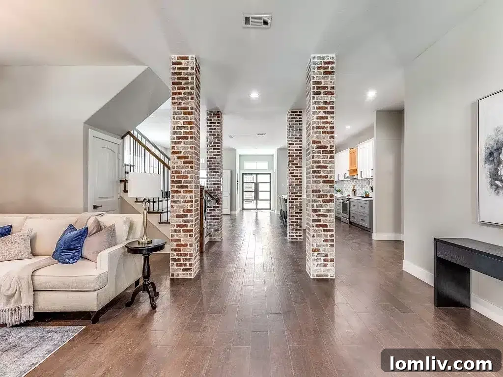 Interior brick pillars and rich wood flooring accent the first floor of 5409 Pershing Avenue, creating a warm, inviting atmosphere.