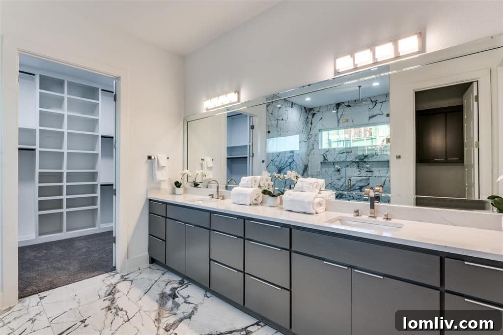 Luxurious en-suite bathroom featuring dual vanities, a freestanding tub, and a spacious walk-in shower