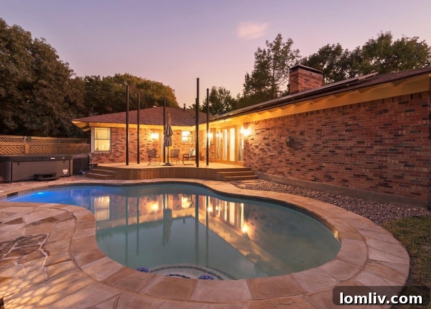 Wynnewood North Midcentury: A Tour of Its Irresistible Charms 13 Outdoor deck area with comfortable seating situated directly next to the swimming pool, offering an ideal spot for relaxation and entertainment.