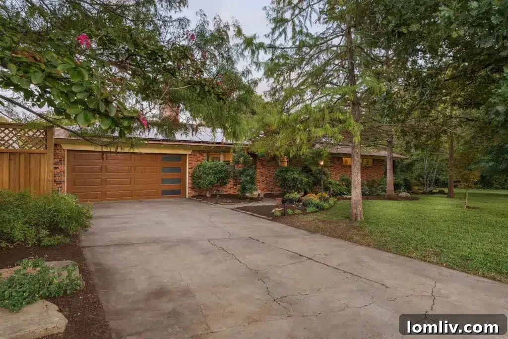 Wynnewood North Midcentury: A Tour of Its Irresistible Charms 4 Landscaped front yard of a Wynnewood North home featuring mature trees and a well-maintained lawn, contributing to its attractive curb appeal.