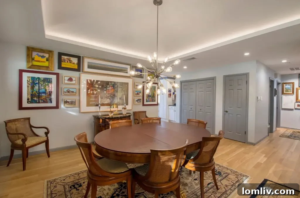 Wynnewood North Midcentury: A Tour of Its Irresistible Charms 6 Contemporary kitchen with sleek cabinetry, a large central island, and modern pendant lighting, designed for both aesthetics and functionality.