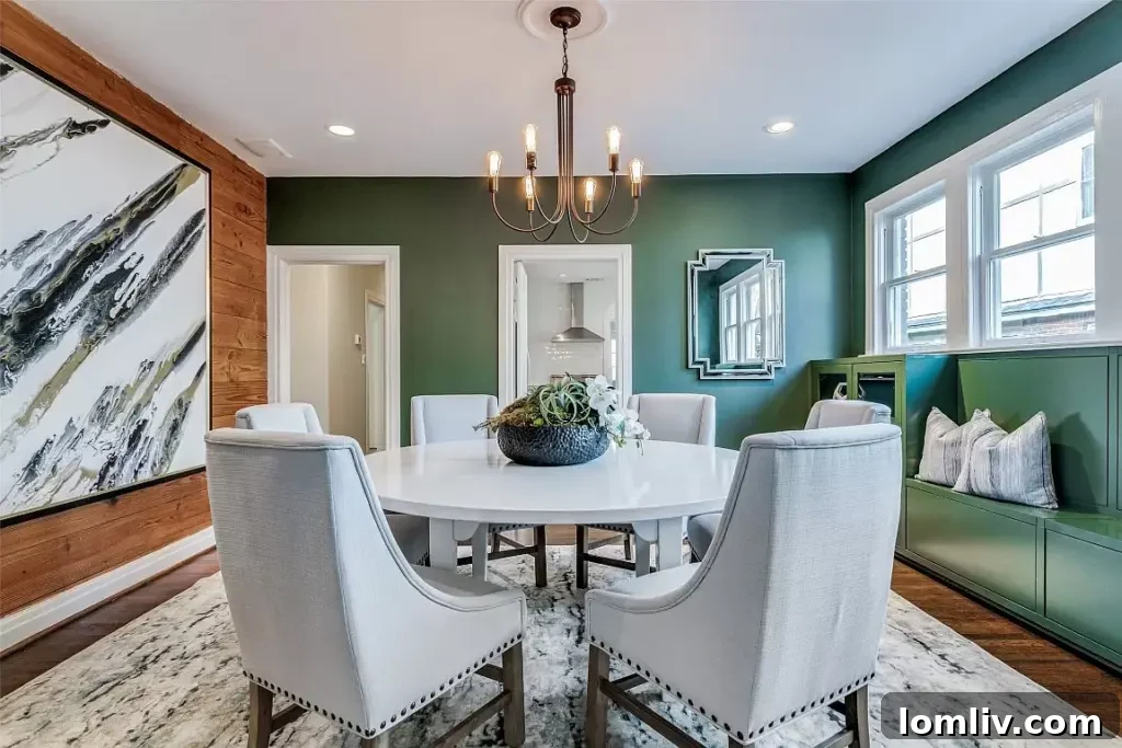 Elegant formal dining room with dark green walls, built-in cabinetry, and a rich wood accent wall.