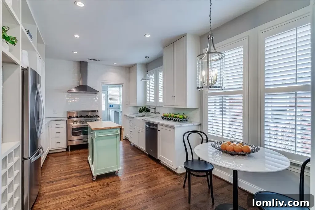 Modern kitchen featuring stainless steel appliances, a gas range, a wine fridge, and ample storage.